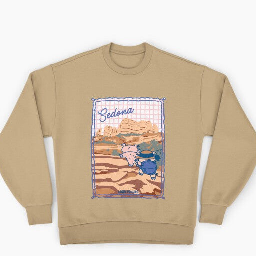 Beige sweatshirt with a graphic design of a desert scene and 'Sedona' text on a white background